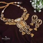 The jewelry set consists of a kemp stone-studded heavy choker along with fine temple gold polish and a pair of matching dangler earrings. necklace secured with drop-down closure and earrings secured with the post and back closure.